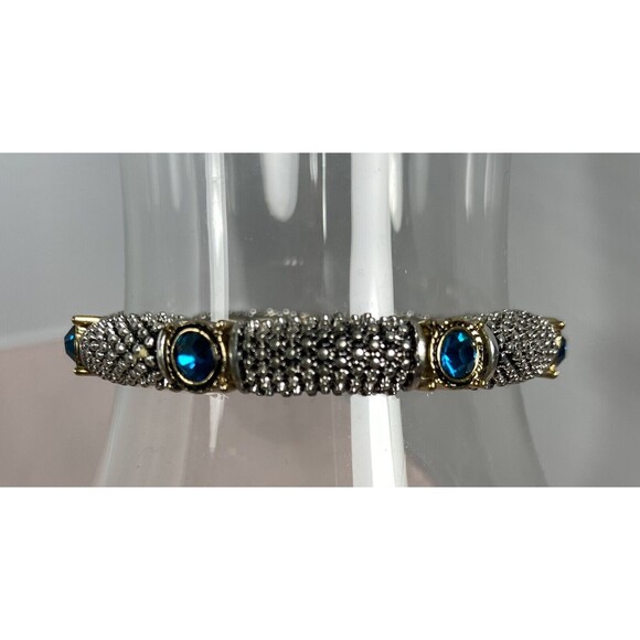 SILVER WITH GOLD ACCENTS & BLUE TOPAZ COLORED STONES. 7 STONES ON BRACELET - Picture 1 of 3